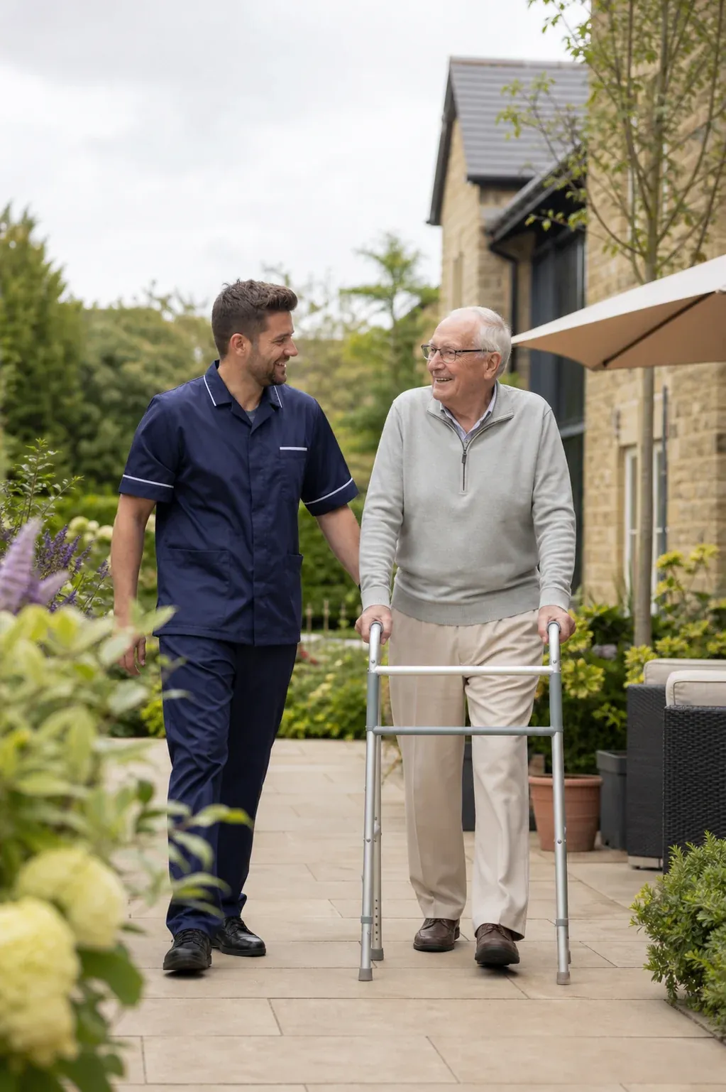 A care professional walking with a resident in a garden
